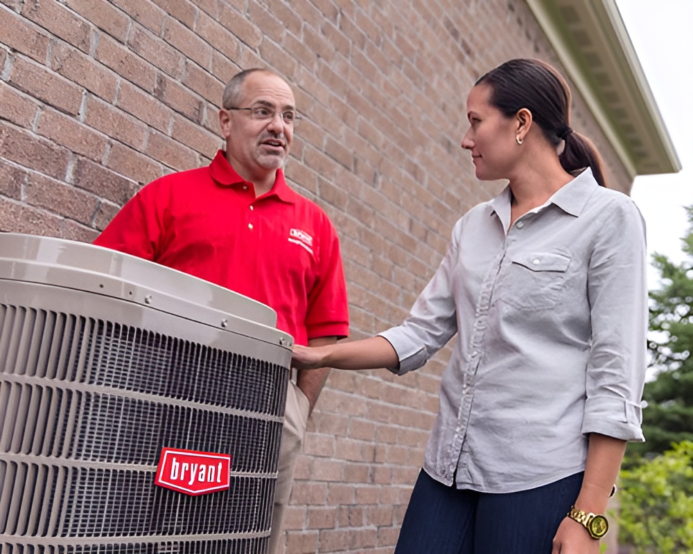Two people talking beside an air conditioner