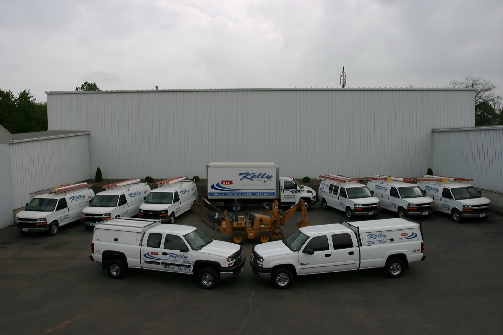 Kelly Heating and Electric service vehicles outside the Eau Claire shop